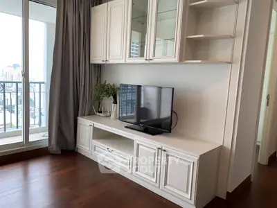 Modern living room with sleek TV cabinet and balcony view
