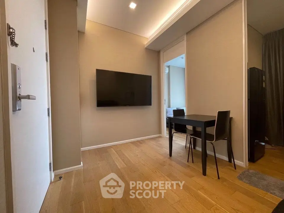 Modern apartment interior with wall-mounted TV and dining area