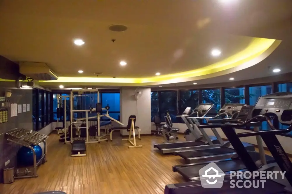 Spacious modern gym with state-of-the-art equipment and ambient lighting