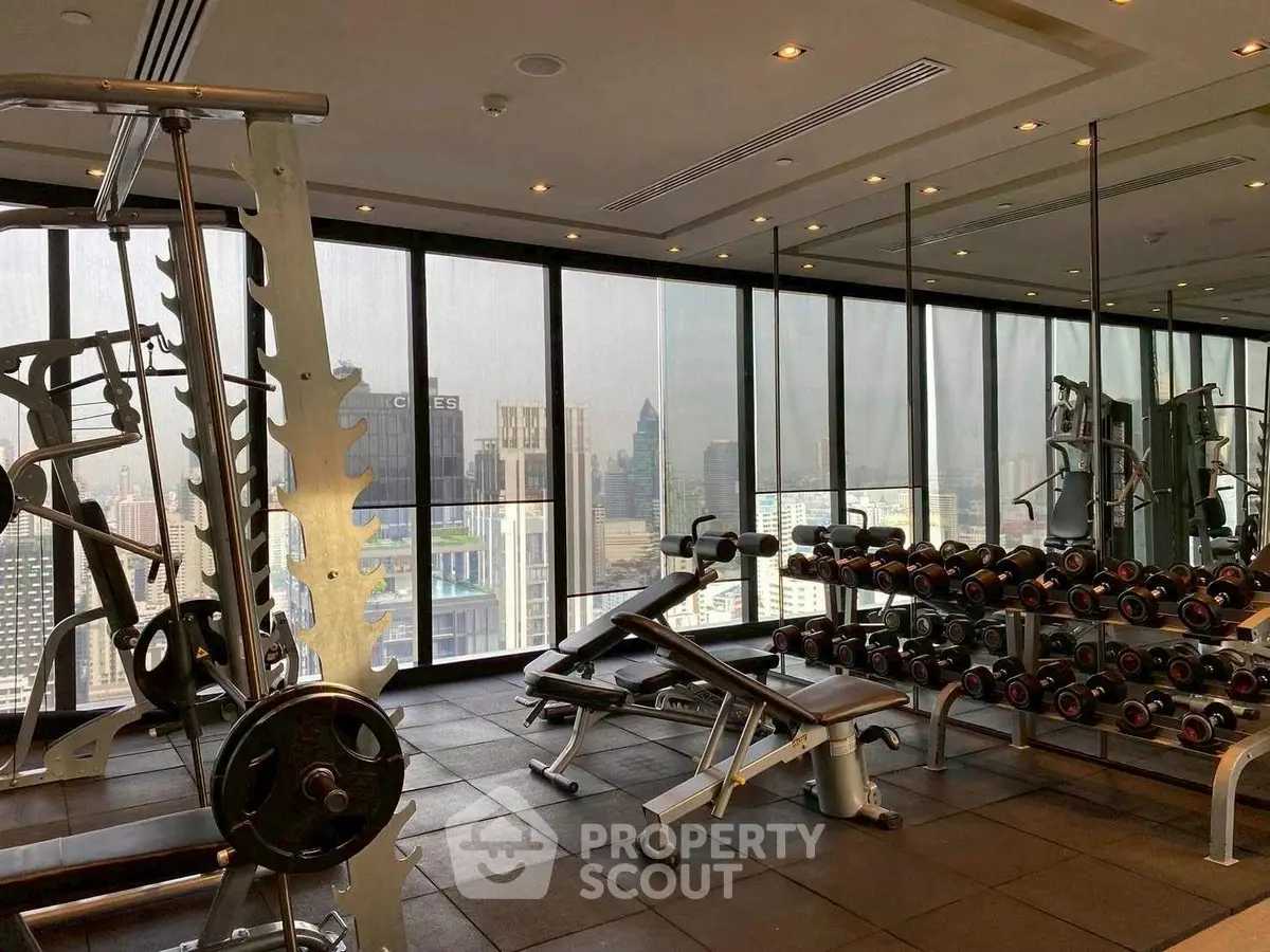 Luxurious high-rise gym with panoramic city views and modern fitness equipment.