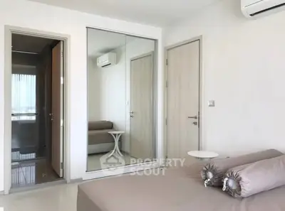 Modern bedroom with mirrored closet and air conditioning in a stylish apartment