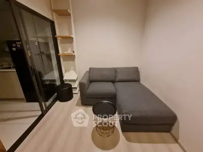 Cozy living room with modern gray sofa and stylish decor in a compact apartment.