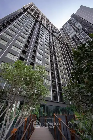 Stunning modern high-rise building with lush greenery and sleek architectural design.