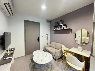 Modern living room with stylish decor, featuring a cozy sofa, wall-mounted TV, and elegant marble coffee table.