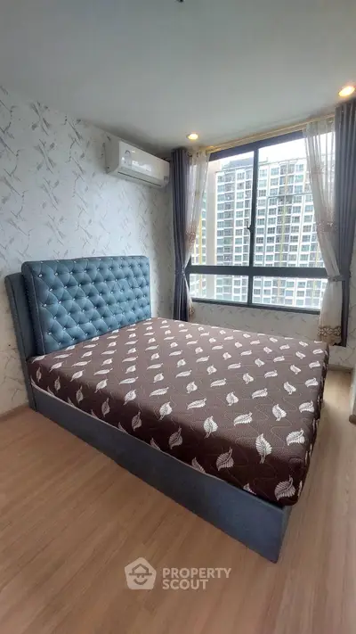 Modern bedroom with large window and stylish bed in high-rise apartment