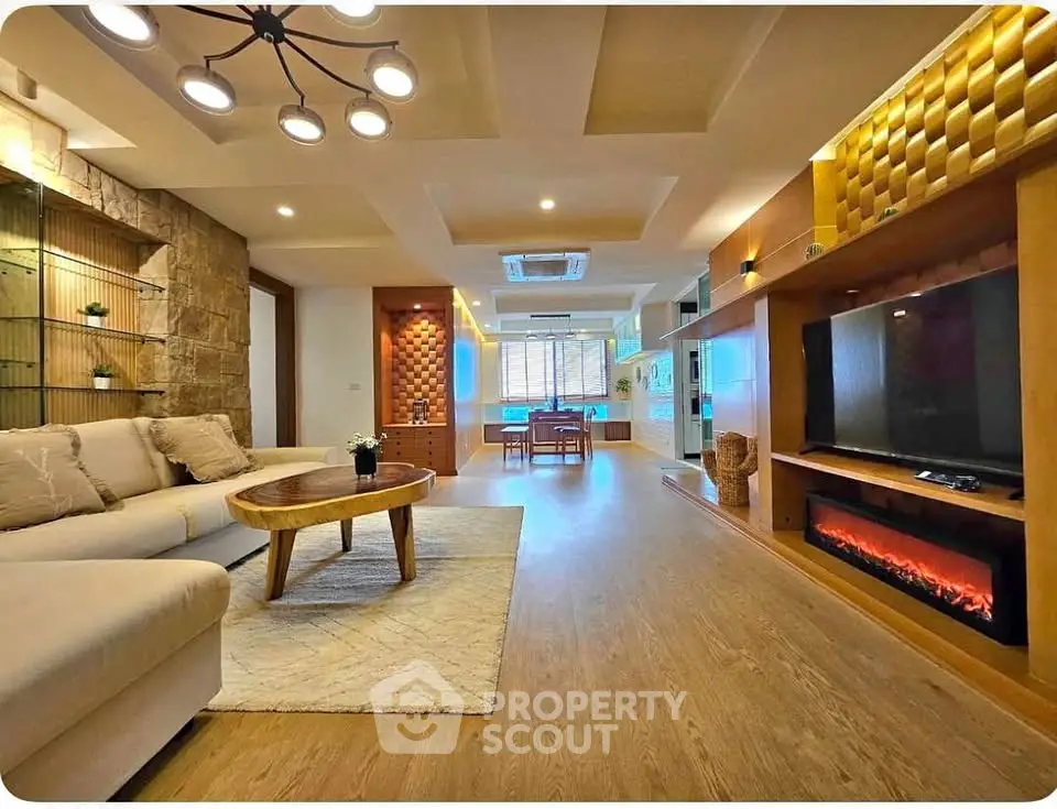 Spacious modern living room with elegant lighting and cozy fireplace