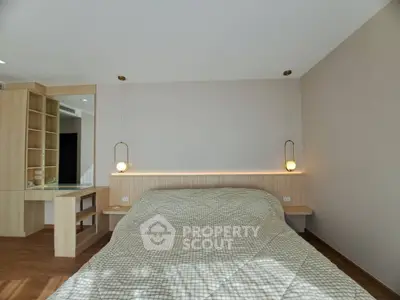 Modern bedroom with stylish lighting and cozy decor, perfect for relaxation.