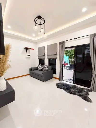 Modern living room with sleek design, featuring a cozy sofa, elegant lighting, and access to a balcony with a view.