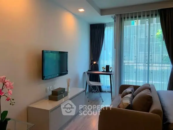 Modern living room with natural light and stylish decor in a cozy apartment.
