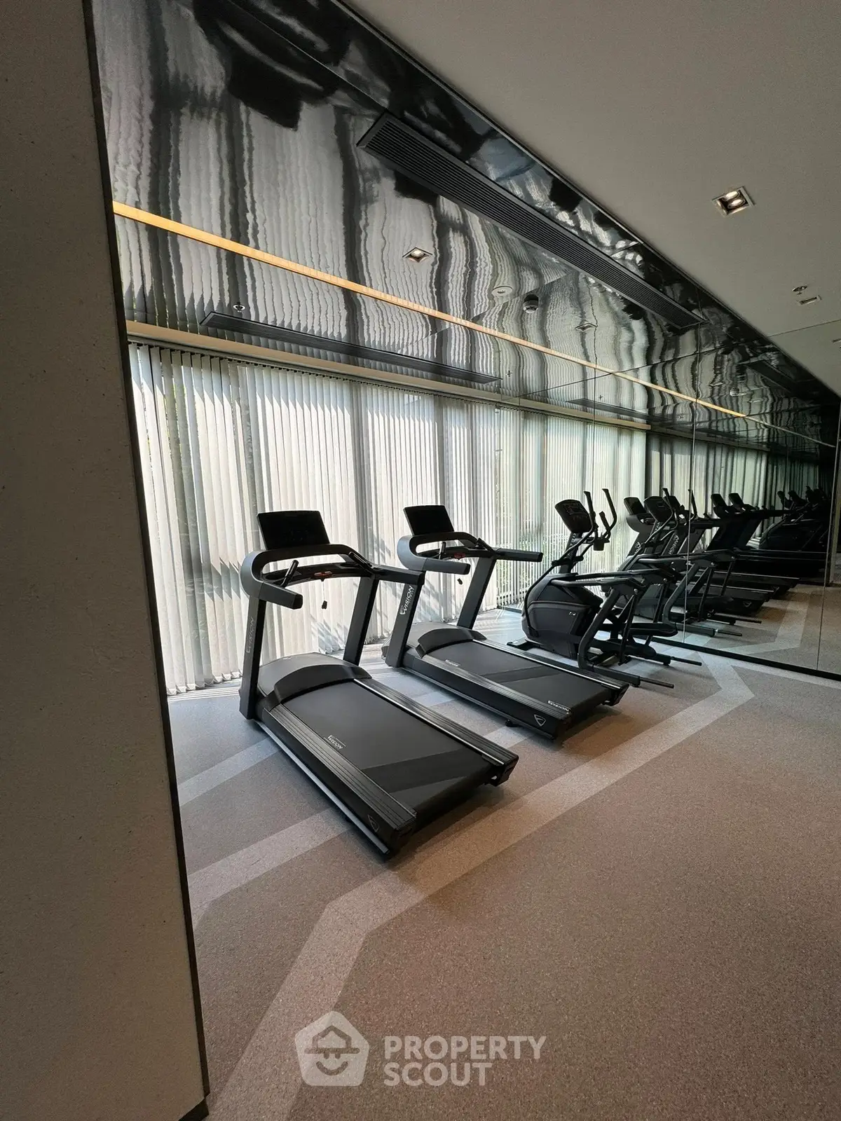 Modern gym with state-of-the-art treadmills and exercise equipment in a sleek interior.