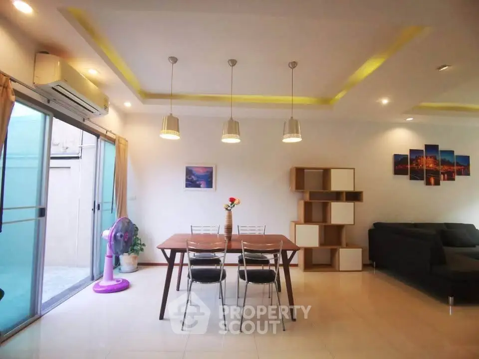 Modern living room with stylish dining area and contemporary lighting
