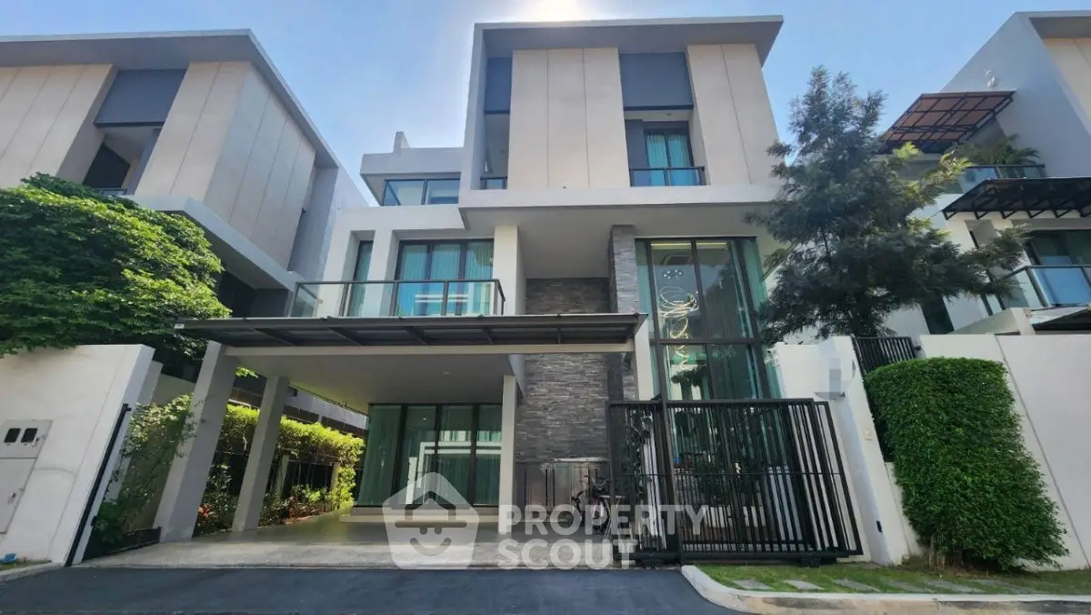 Modern three-story townhouse with sleek design and spacious driveway in a serene neighborhood.