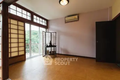 Spacious room with sliding doors and balcony view, perfect for serene living.