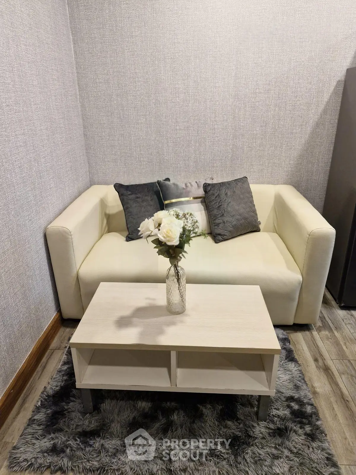 Cozy living room with modern sofa and stylish coffee table, perfect for relaxation.