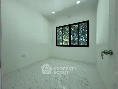 Bright empty room with large windows and marble flooring, perfect for customization.