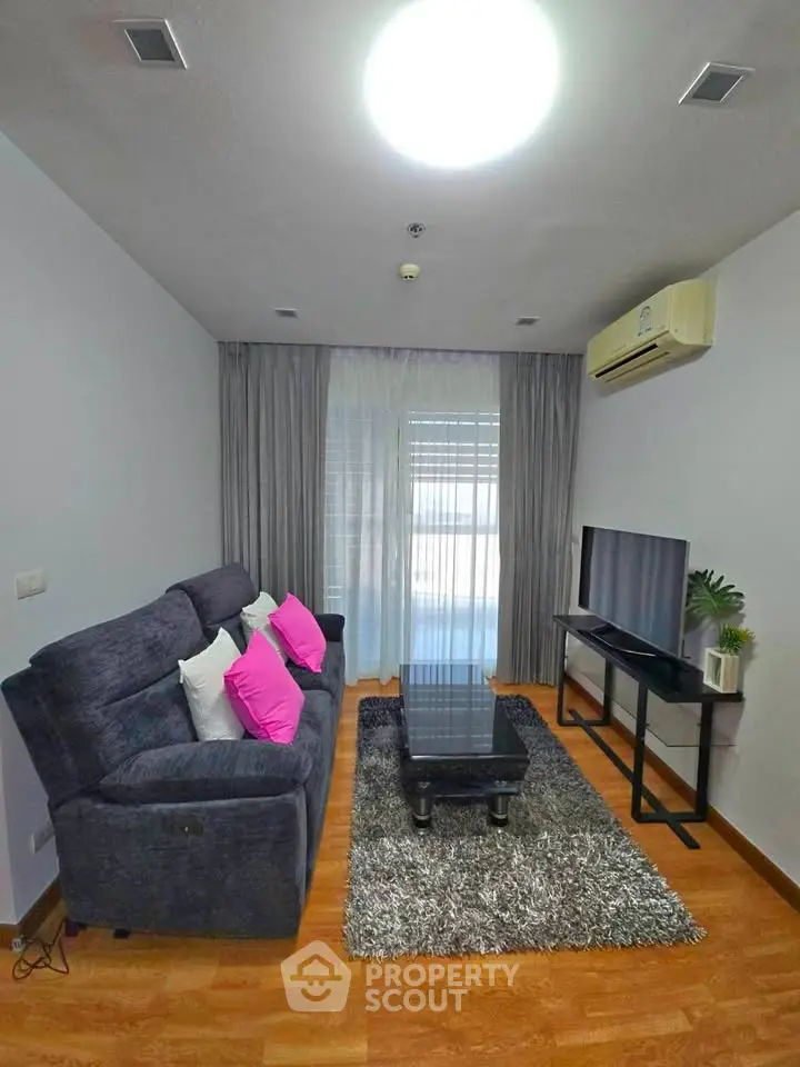Modern living room with cozy sofa, stylish decor, and natural light.