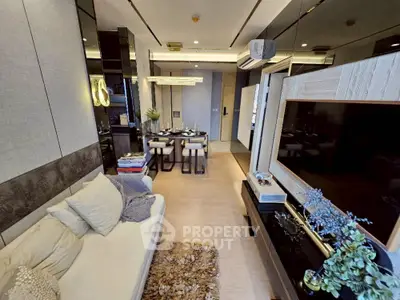Modern living room with elegant decor and dining area, featuring a cozy sofa and stylish lighting.