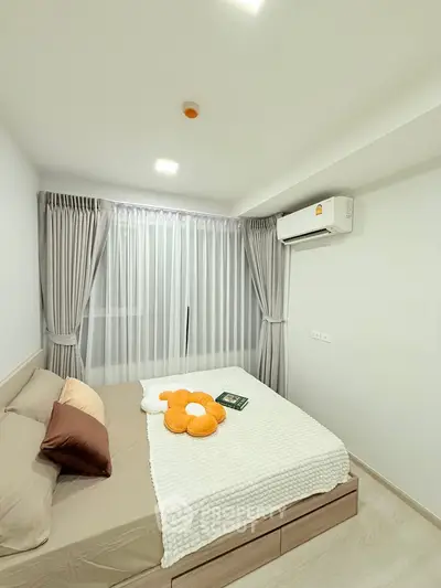 Modern bedroom with cozy decor and air conditioning in a bright apartment.