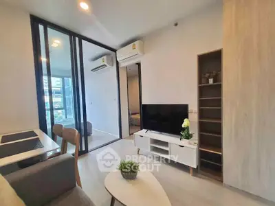 Modern living room with sleek furniture and large windows in a stylish apartment.