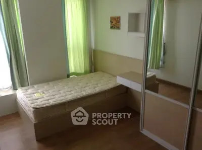 Cozy bedroom with modern design and ample natural light, featuring a comfortable bed and stylish decor.