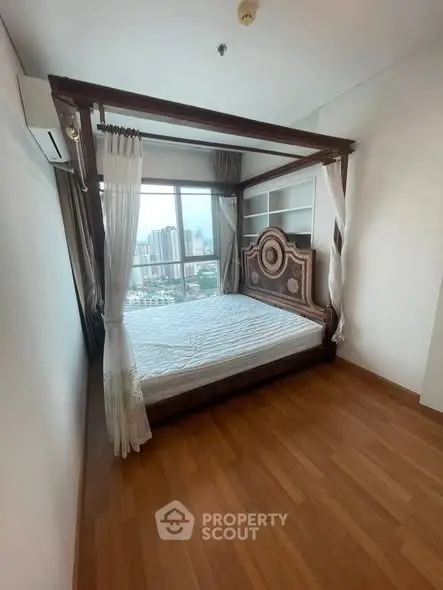 Luxurious bedroom with elegant wooden bed and city view in high-rise apartment