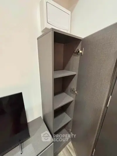 Modern interior with sleek storage cabinet and flat-screen TV, perfect for compact living spaces.