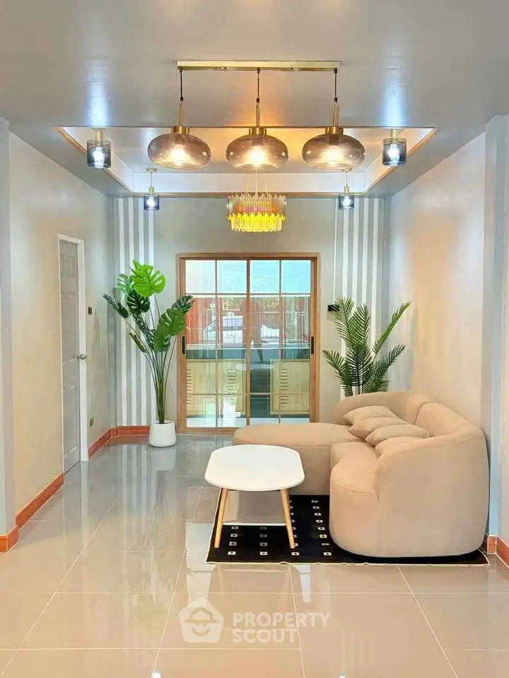 Modern living room with elegant lighting and cozy beige sofa, featuring stylish decor and glossy tiled flooring.