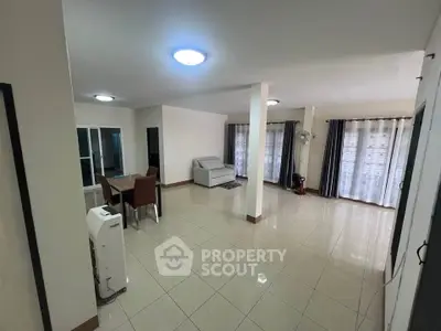 Spacious living room with modern furniture and large windows for natural light.