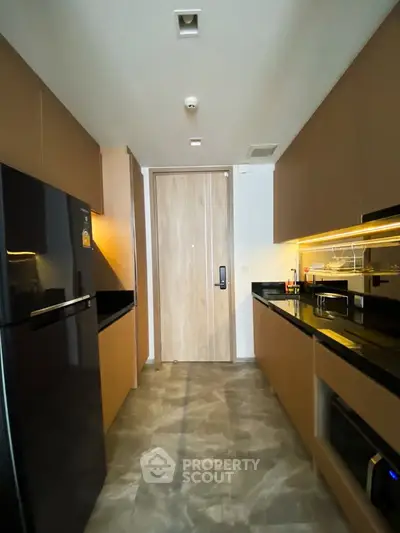 Modern kitchen with sleek cabinetry and built-in appliances in a stylish apartment.