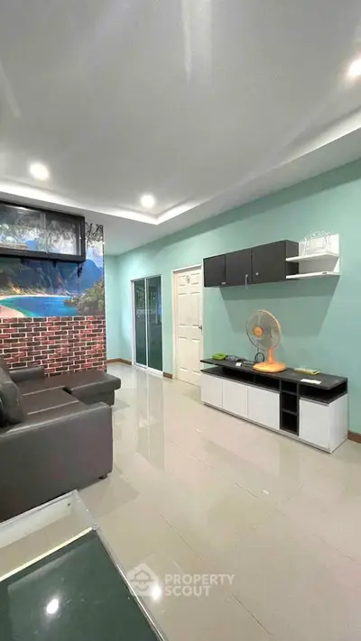 Modern living room with sleek furniture and vibrant wall art, perfect for relaxation and entertainment.