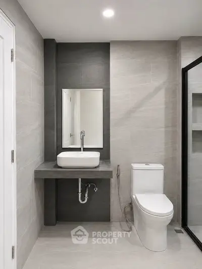 Modern bathroom with sleek design, featuring a stylish sink and toilet, perfect for contemporary living.