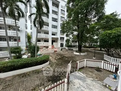 Charming residential building with lush greenery and inviting entrance
