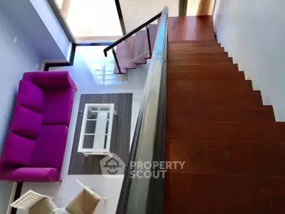 Modern duplex with stylish staircase and vibrant living area