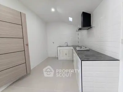 Modern minimalist kitchen with sleek cabinetry and gas stove