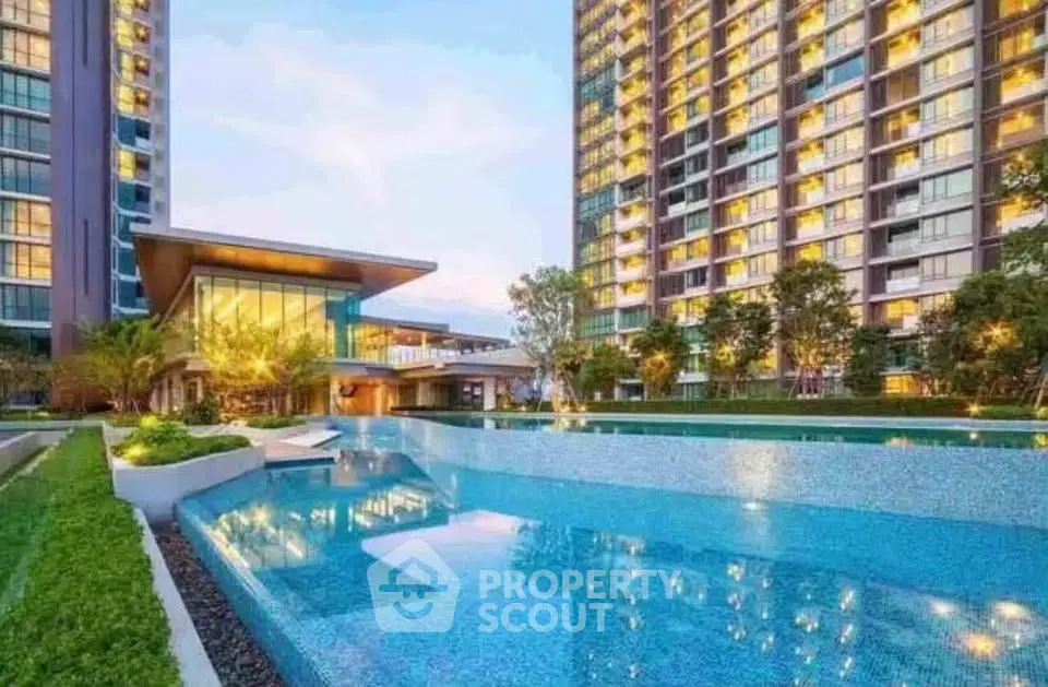 Luxurious condominium with stunning pool and modern architecture in vibrant urban setting.