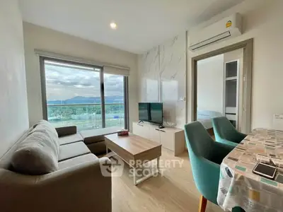 Modern living room with scenic view, cozy seating, and stylish decor in a contemporary apartment.