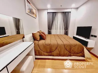 Spacious bedroom with polished hardwood floors, modern furnishings, and ample natural light, perfect for relaxation and comfort.