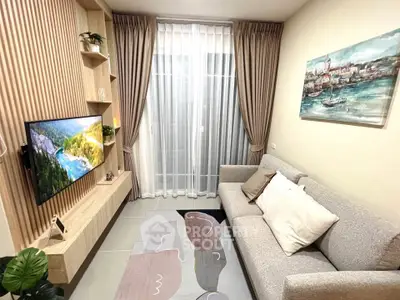 Cozy living room with modern decor, wall-mounted TV, and elegant curtains.