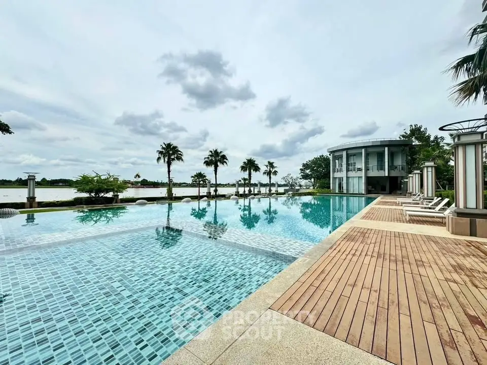 Luxurious infinity pool with stunning waterfront view and modern architecture.