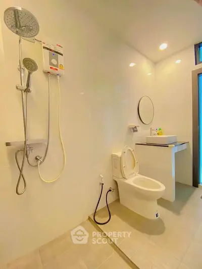 Modern bathroom with shower and sleek fixtures in a bright, minimalist design.