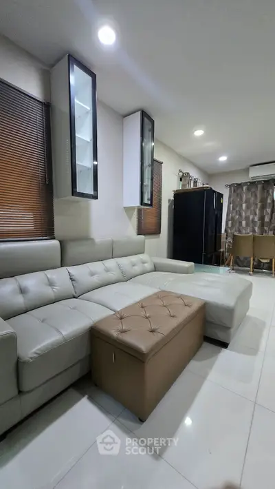 Spacious modern living room with sleek leather sofa and elegant decor