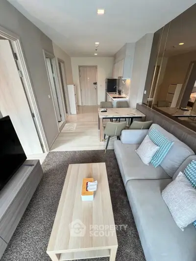 Modern living room with sleek furniture and open kitchen layout