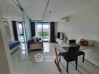 Modern open-plan living room with dining area and balcony view