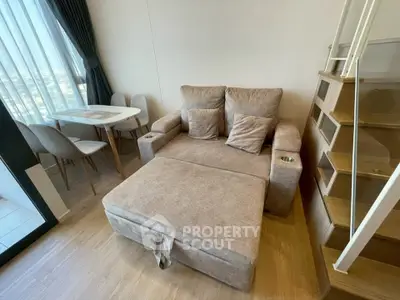 Modern living room with cozy sofa and dining area in stylish apartment
