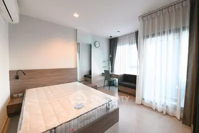 Spacious modern bedroom with large windows and elegant decor