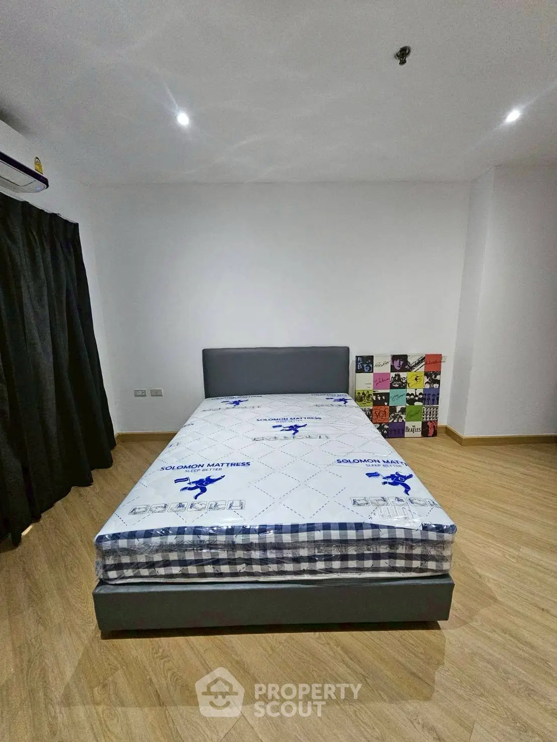 Spacious bedroom with modern design and comfortable mattress in a stylish apartment.