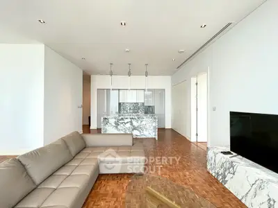 Luxurious modern living room with marble kitchen island and sleek design