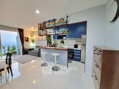 Modern open-plan kitchen and living room with city view and stylish decor