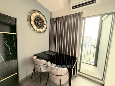 Modern study room with elegant decor and balcony view in a high-rise apartment.