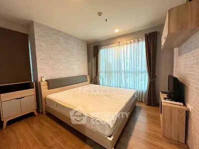 Spacious bedroom with modern decor and large window for natural light